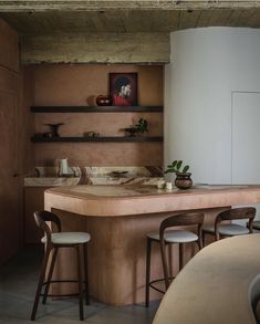 a kitchen counter with stools in front of it