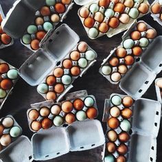 several trays filled with brown and white eggs