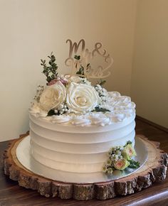 a white wedding cake with flowers on top