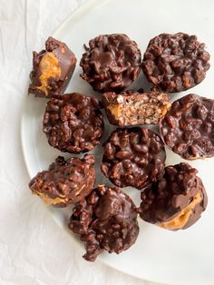 chocolate covered cookies are on a white plate