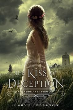 the kiss of deception book cover with an image of a woman standing in tall grass