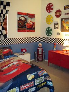 a bedroom with cars themed decor on the walls