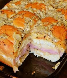 a ham and cheese roll cut in half on a baking sheet with a fork next to it