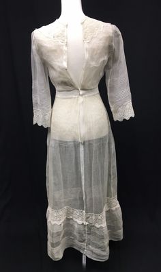 "Absolutely beautiful 1910s Edwardian Silk Organza Day Dress for a Petite young lady - Crew neck and cuffs trimmed in Venise machine lace - Front decorated with crochet covered buttons (non functional) - Pin tucks down bodice front and back - Sleeves and other vertical seams are finished with open work - Combination of hand work and machine stitching - Closes in the back with 4 hook and eyes and 1 set of snaps (added later) - Bottom of skirt is also detailed with pin tucks, machine lace and open Fitted Historical Vintage Dress, Victorian Dress With Long Sleeves And Historical Design, Historical Long Sleeve Daywear Dress, Historical Long Sleeve Day Dress, Historical Long-sleeve Day Dress, Historical Long Sleeve Dresses For Daywear, Long Sleeve Dresses With Historical Design For Daywear, Historical Design Long Sleeve Dress For Daywear, Regency Style Long Sleeve Vintage Dress For Daywear