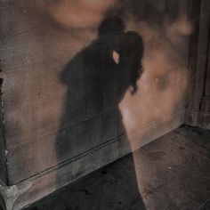 the shadow of a person standing in front of a wall