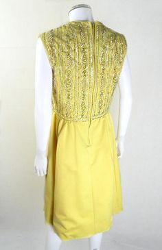 "Amazing Original 1950s Vintage Yellow Beaded Cocktail Dress UK Size 12 Wow! We adore this glorious 50s cocktail dress in all it's yellow glory! Fitted bodice encrusted with stunning silver beads, pearls and iridescent sequins for the ultimate in vintage glamour. This mid-toned yellow looks great on most skin tones and the fit and flare style is super flattering! Made by the Miss Smart label from a lovely heavyweight cotton, this is perfect for special occasions, black tie events and more! Non s 1950s Style Yellow Dress For Vintage Fashion, Yellow 1950s Style Dress For Vintage Fashion, 1950s Style Yellow Party Dress, Yellow Vintage Dress For Vintage Events, Fitted Yellow Vintage Dress For Party, Yellow Fitted Vintage Dress For Parties, Yellow 1950s Sleeveless Dress, Yellow 1950s Style Sleeveless Dress, Yellow Sleeveless 1950s Dress