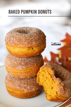 three pumpkin donuts stacked on top of each other