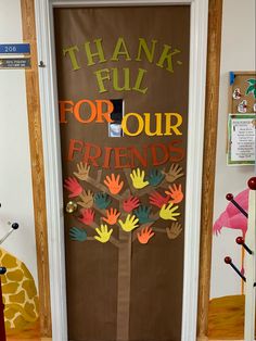 a door decorated with handprints and the words thank full for our friends