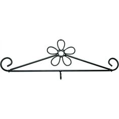 a wrought iron shelf with an ornate flower design on the top and two hooks attached to it