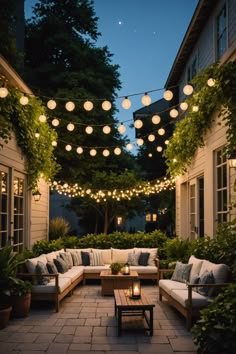 an outdoor seating area with lights strung over it