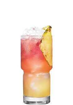 a tall glass filled with ice and a pineapple on the rim next to a slice of fruit