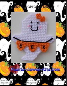 a cross stitch ghost with an orange bow on it's head is shown in front of a black and white background