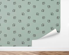 a dog paw print wallpaper in a room with wood flooring and green walls