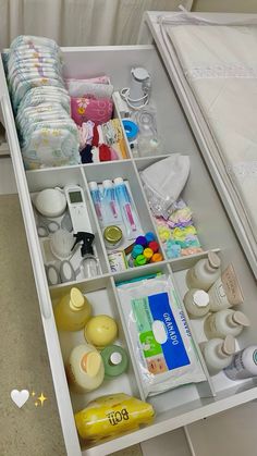 an open drawer filled with lots of baby products and items on it's side