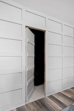 an empty room with white painted walls and wood flooring is seen in this image