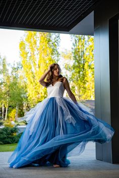 a woman in a long blue and white dress