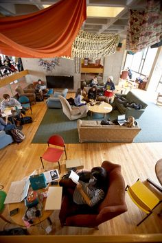 an overhead view of people sitting and standing in a living room