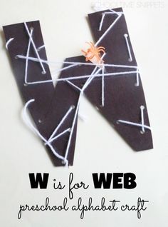 a black piece of paper with white thread on it and the words w is for web preshal alphabet craft