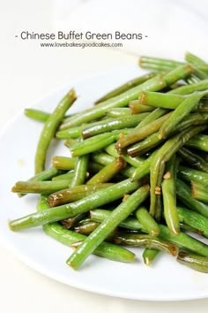 a white plate topped with green beans covered in seasoning