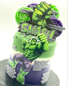 the hulk cake is decorated with green and purple icing