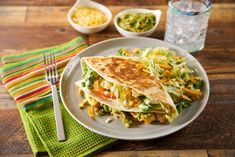 a white plate topped with a quesadilla and salad