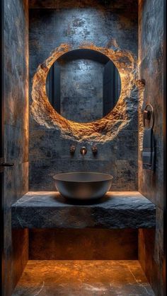 a bathroom with a round sink and stone counter top in the center, surrounded by black walls