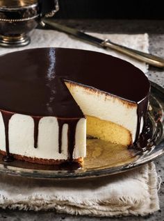 a chocolate and white cheesecake on a glass plate