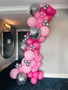 a bunch of balloons that are in the shape of a number one on a wall