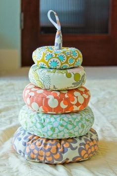 a stack of pillows sitting on top of a bed