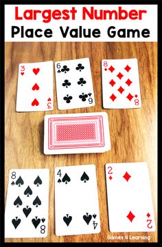 the large number place value game is shown with four playing cards in front of it