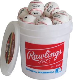 a bucket filled with baseballs sitting on top of a white table