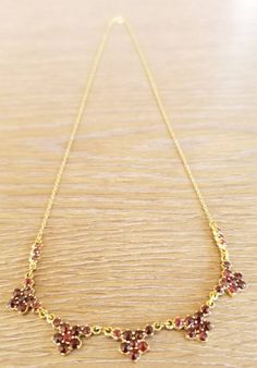 "This is an antique garnet and gold flower necklace. It is marked \"333\" on the closure for 8k gold. This piece is in excellent vintage condition. This necklace measures 17 inches." Formal Yellow Gold Garnet Necklaces, Formal Yellow Gold Garnet Necklace, Victorian Garnet Necklace, Vintage Garnet Gemstone Necklace, Gold Garnet Birthstone Necklace, Victorian Garnet Necklace For Gift, Victorian Garnet Necklace Gift, Victorian Brown Necklace For Gift, Vintage Red Garnet Necklace