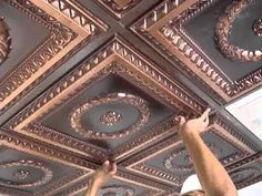 a man is painting the ceiling in an ornate room