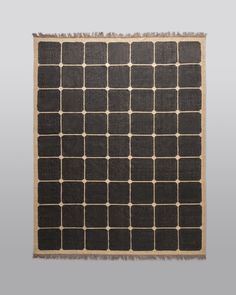 a black and beige rug with squares on it