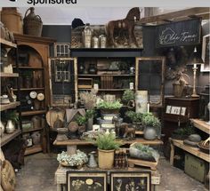 a room filled with lots of different types of furniture and decor on top of wooden shelves