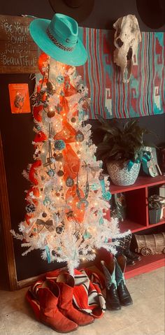 a white christmas tree with orange and blue decorations