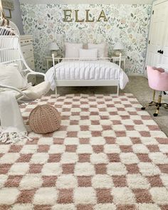 a white bed sitting in a bedroom on top of a carpeted floor next to a pink chair