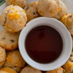 a white plate topped with cookies next to a cup of sauce