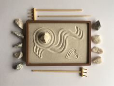 an image of some rocks and sticks in the shape of a horse on a tray