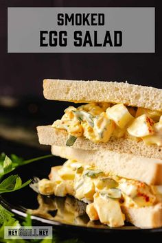 an egg salad sandwich is stacked on top of each other with the words, smoked egg salad