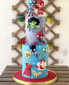 the cake is decorated with superheros and stars