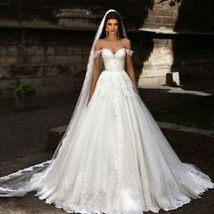 a woman in a wedding dress posing for the camera