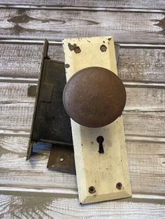 an old door knob on a wooden surface