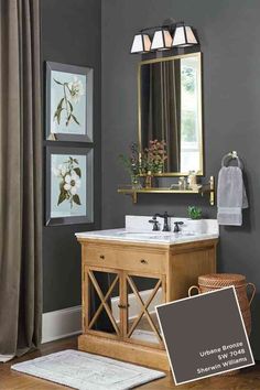 the interior of a bathroom with gray walls and wood furniture, including a vanity sink