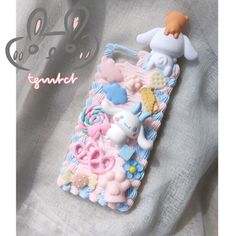 a cell phone case with an animal and other items on it's back cover