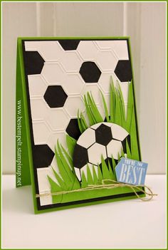 a card with grass and soccer balls on it