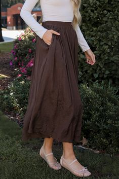 You'll be radiating the most gorgeous energy in the Truly Profound Brown Maxi Skirt! Made from a soft, lightweight fabric, this maxi skirt features a flattering, relaxed fit that cascades elegantly to the floor. The rich brown hue offers a warm, earthy tone, making it easy to pair with a variety of tops, from casual tees to dressy blouses. With a comfortable elastic waistband, this skirt ensures a perfect fit while allowing for ease of movement. Whether you’re heading to the beach, running erran Brown Maxi Skirt, Dressy Blouses, Brown Maxi Skirts, Beach Running, Casual Tees, Dressy Blouse, Casual Tee, The Floor, Lightweight Fabric