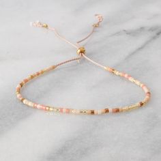 "Sweet delicate beaded bracelets are the perfect gift. (And yes, self-gifting is highly recommended!) Buy more and save more! + style shown in main image: SUNRISE + glass and gold-plated seed beads, on blush silk cord + adjustable from 5\" - 9\" + sliding bead makes for easy on/off design + finished with gold filled crimps that won't tarnish + all Libby & Smee beaded bracelets come packaged on a logo card in a clear resealing bag for storage and gift giving EXCLUSIVE STYLES ARUBA: teal, turquois Handmade Peach Beaded Bracelets As Gift, White Delicate Adjustable Friendship Bracelets, Handmade Peach Beaded Bracelets For Gift, Delicate Adjustable White Friendship Bracelets, Delicate White Adjustable Friendship Bracelets, Dainty Adjustable Hand-strung Beaded Bracelets, Cream Beaded Pearl Bracelet As A Gift, Beige Jewelry Gift With Sliding Knot, Adjustable Peach Beaded Bracelets As Gift