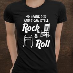 a woman wearing a black shirt that says 40 years old and i can still rock and roll