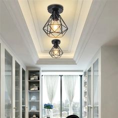 a dining room table and chairs in front of a window with lights on the ceiling